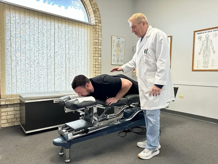 Dr. Patrick Balsier performing a full-spine chiropractic adjustment at Crest Hill Clinic near Joliet, IL