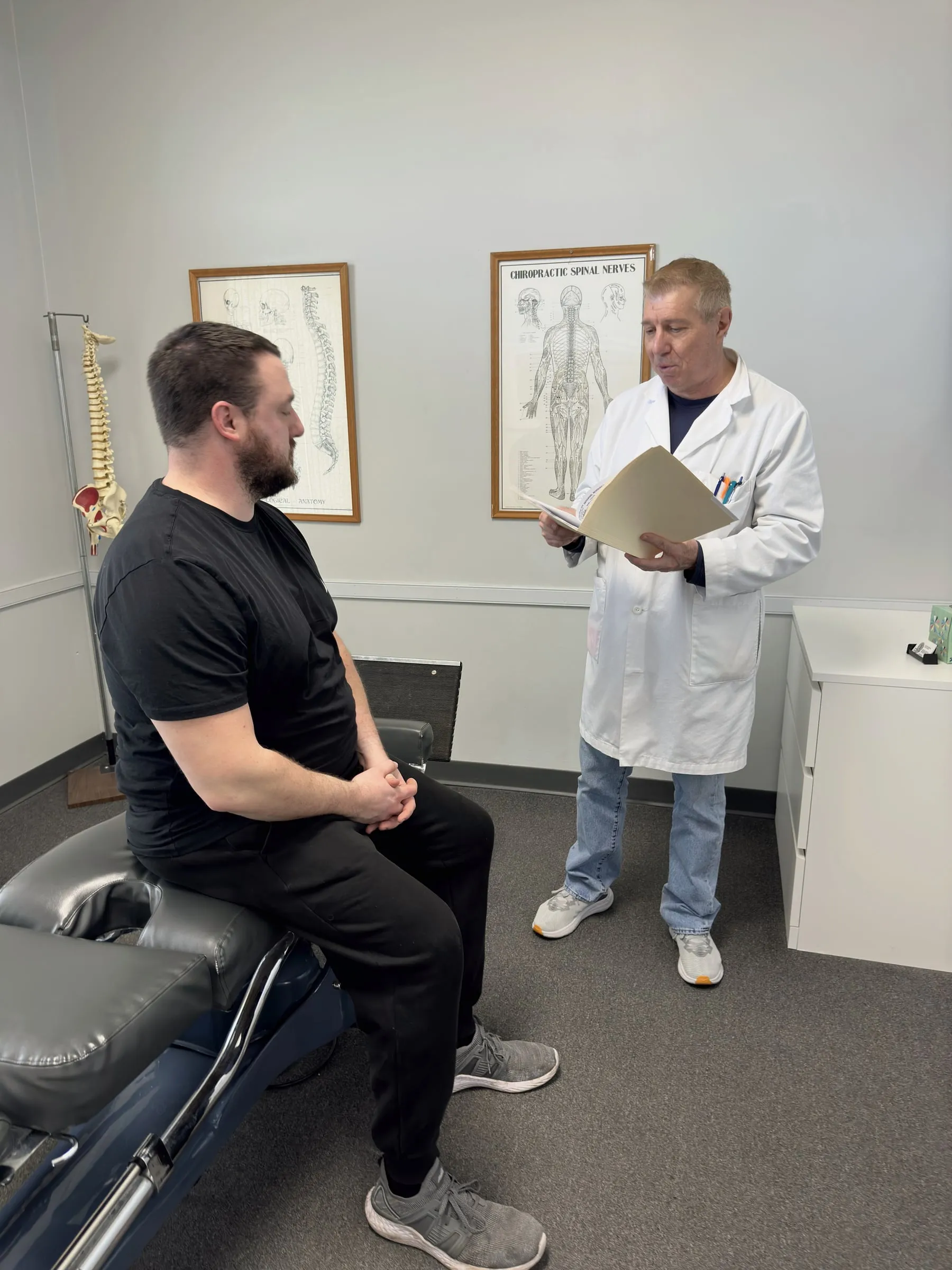 Dr. Patrick Balsier reviewing a patient's chart at Crest Hill Clinic near Joliet, IL