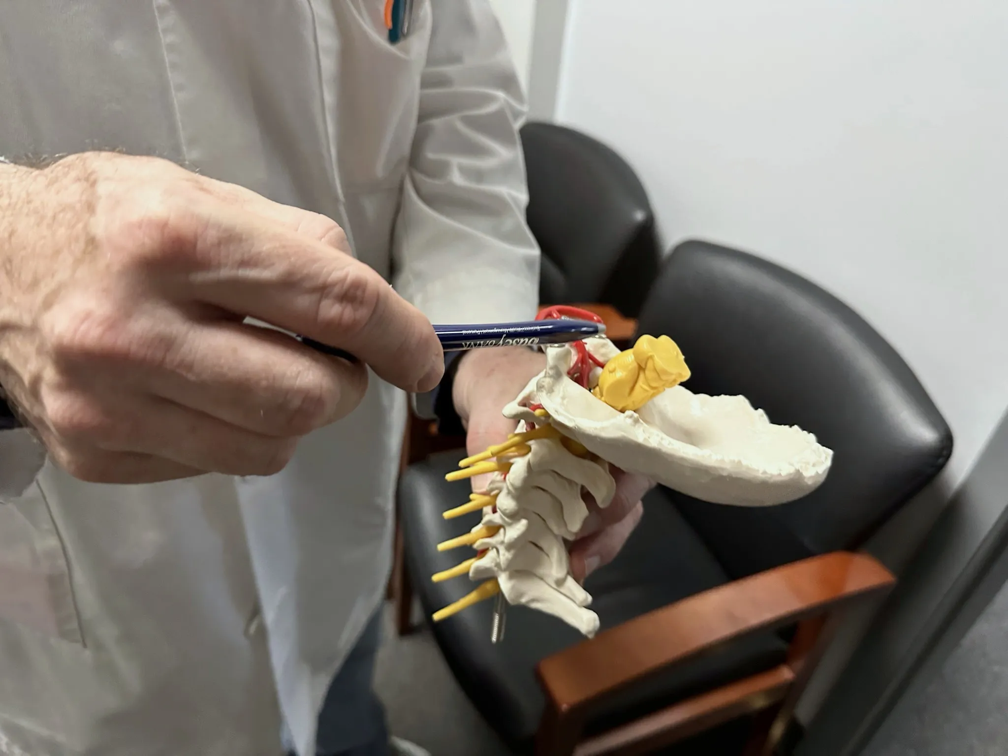Dr. Patrick Balsier explaining a cervical spine model to a patient at Crest Hill Clinic near Joliet, IL