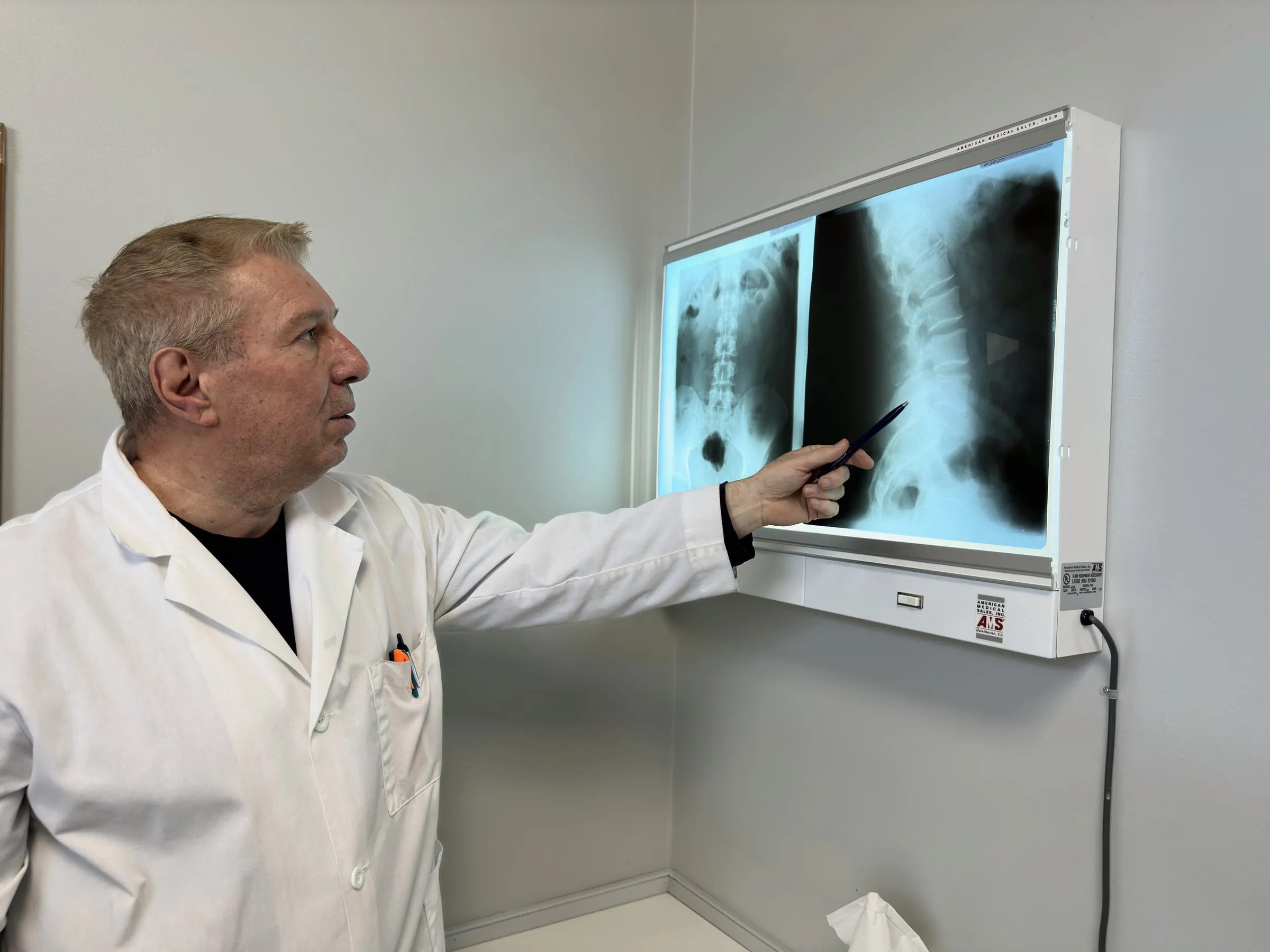 Dr. Patrick Balsier reviewing a spinal X-ray with a patient at Crest Hill Clinic near Joliet, IL