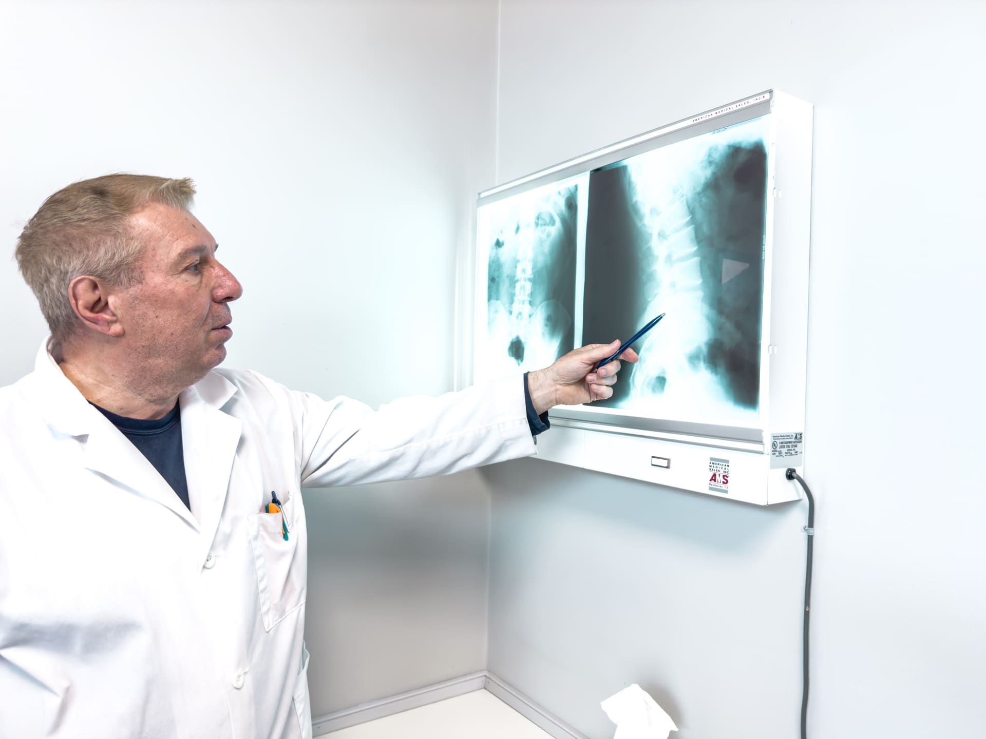 Crest Hill Clinic chiropractor reviewing a spinal X-ray near Joliet