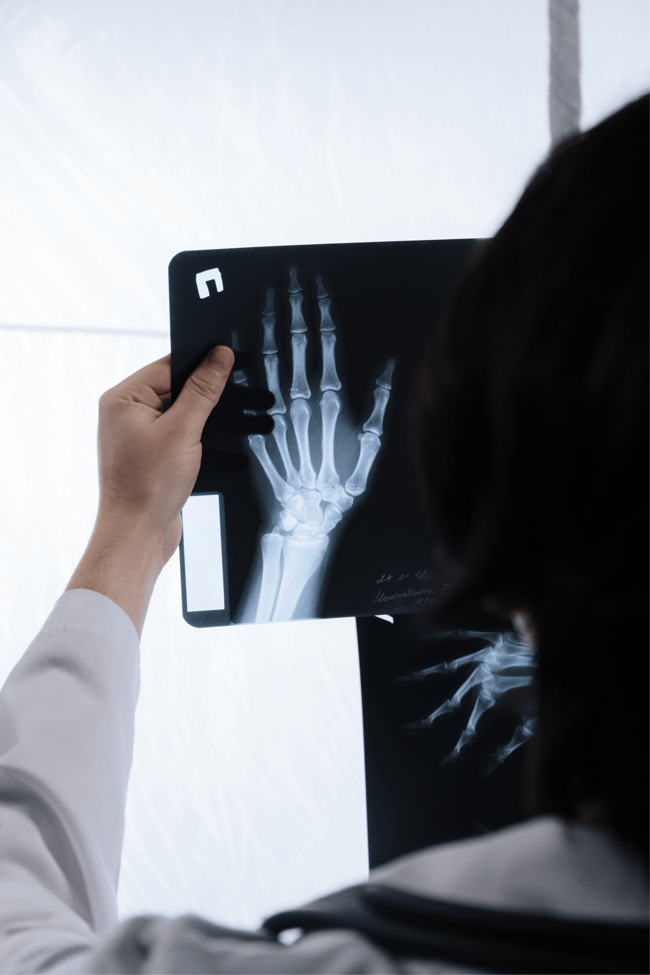 Chiropractor reviewing a hand x-ray at Crest Hill Clinic