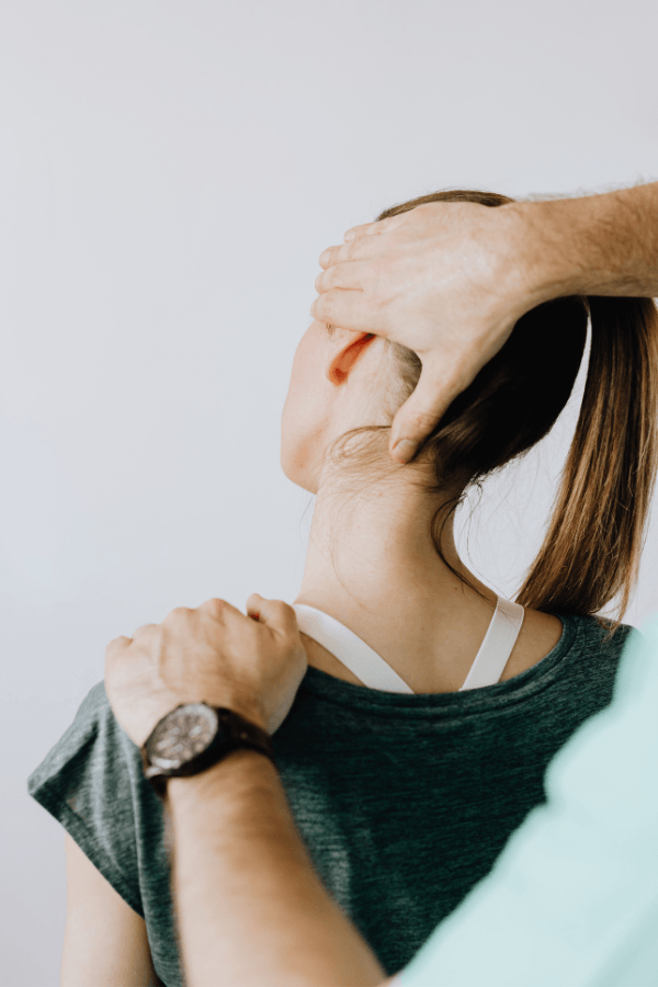 Chiropractor performing a gentle neck adjustment on a patient at Crest Hill Clinic